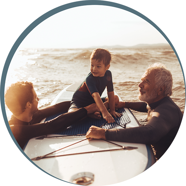 Father, Grandfather and young son surfing