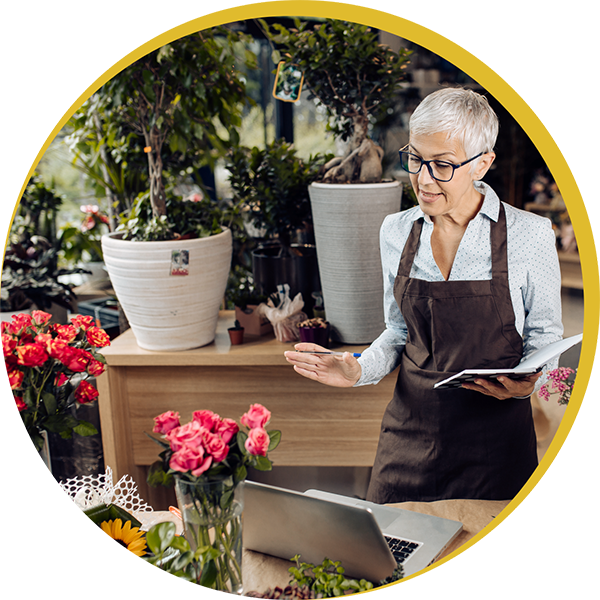 Older woman tending flowers in garden