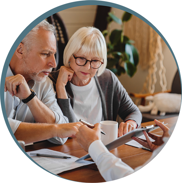 Older couple reviewing documents with advisor